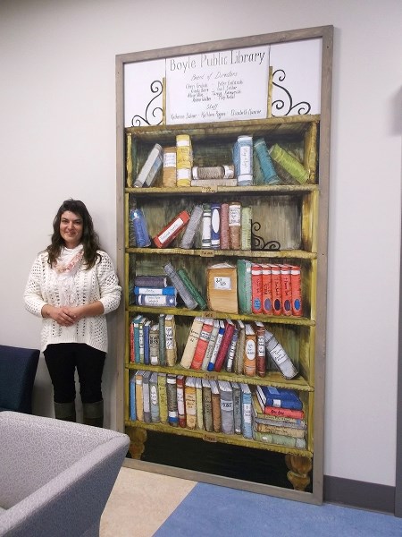 Tatyana Beer painted the new mural in the Boyle Public Library, naming the many donors to the facility.