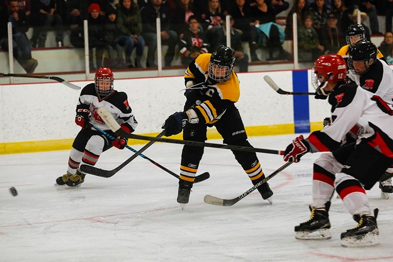 Athabasca Hawks captain Carsen Runcer takes a wrist shot on the Boyle net during the third period.