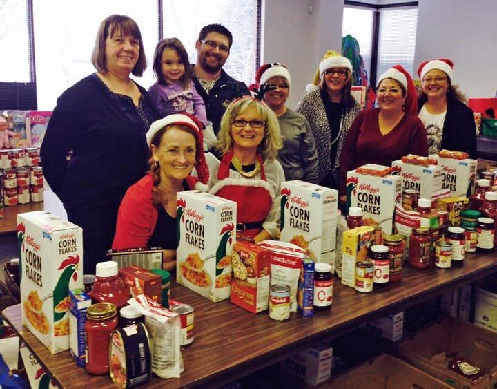 Boyle Santas Anonymous volunteers pose with top donors in 2014. The group is looking for volunteers to run the committee this year.