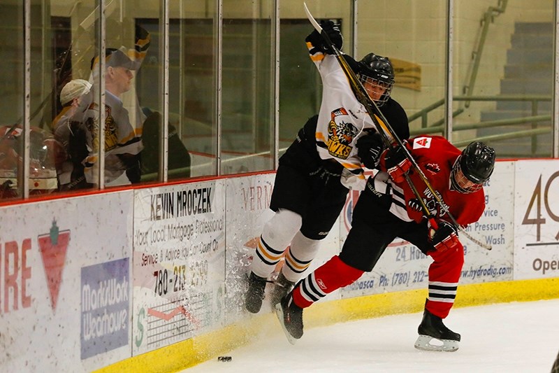 Midget &#8216;B&#8217; Hawks player Ian Klaczek gets hit by a Whitecourt Wolverines forward during the first period of their Saturday night match up. Lamoureux would register 