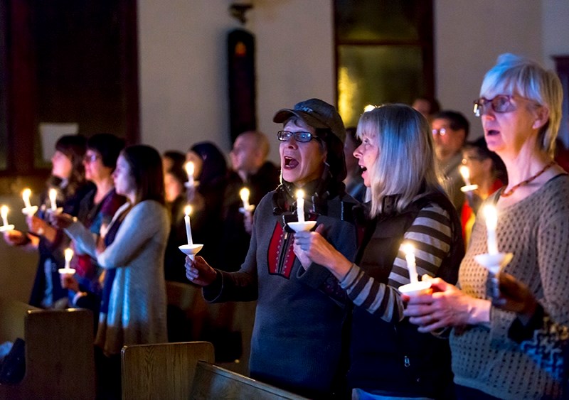 Lois Demcoe, Shirley Stashko and Cheryl Balay sing &quot;This Little Light of Mine&quot; to conclude the candle-lit vigil on Feb. 4 at the Athabasca United Church in