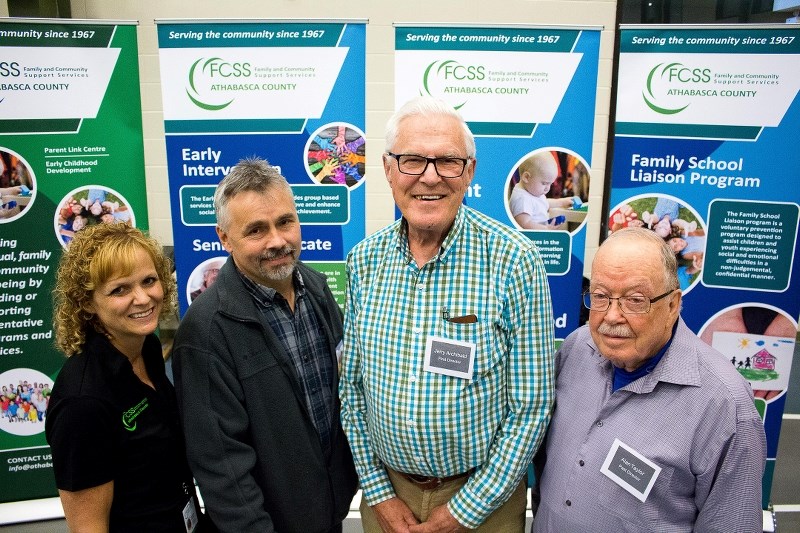 Family Community Support Services manager Debbie Wood stands with former directors Darin Flemmer, Jerry Archibald, Alan Taylor at the FCSS 50th anniversary dinner May 10 at