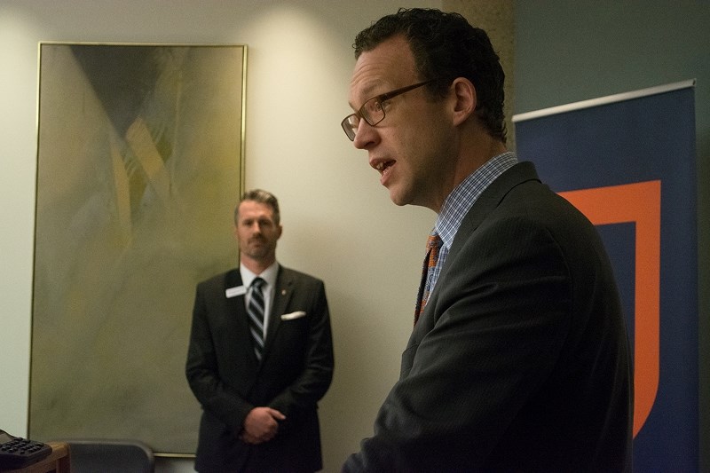 Advanced Education Minister Marlin Schmidt speaks at the release of Ken Coates&#8217; third-party review as Athabasca University president Neil Fassina listens.