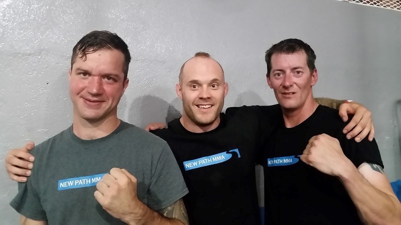 Geoff Loken (left) and Kolt Nahirney (right) stand with New Path MMA owner, operator and fighter Josh Kitchen were in Taber for Loken and Nahirney&#8217;s first fight.