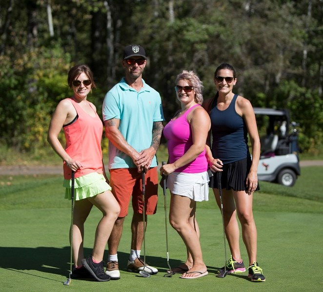Trisha Dennis, Jay Robinson, Michelle Cummings and Lindsey Breckenridge enjoy some nice weather while playing in the Road to Hope golf classic Sept. 7.