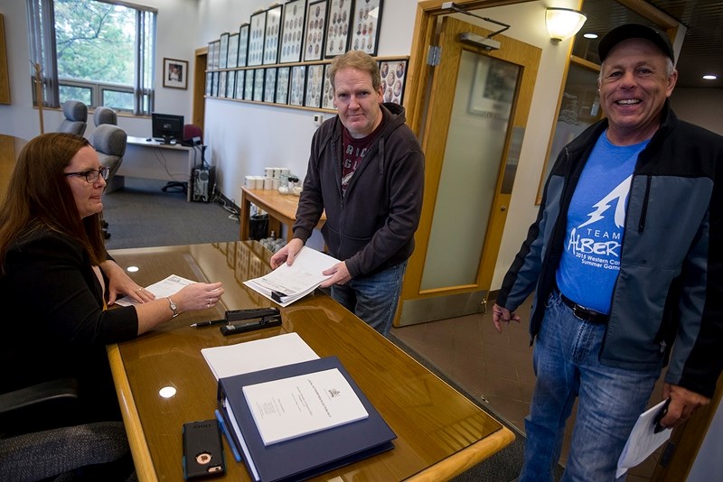 John Traynor (middle) and Rob Baylay submit their nomination forms for Town of Athabasca council Sept. 18 to returning officer Rachel Ramey.