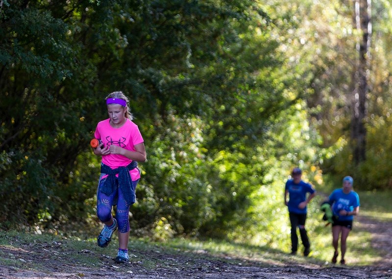 Keira Jardine finishes up her training run in the Muskeg Creek Trails Sept. 14 with the LTIS and EPC dryland cross country skiing team.