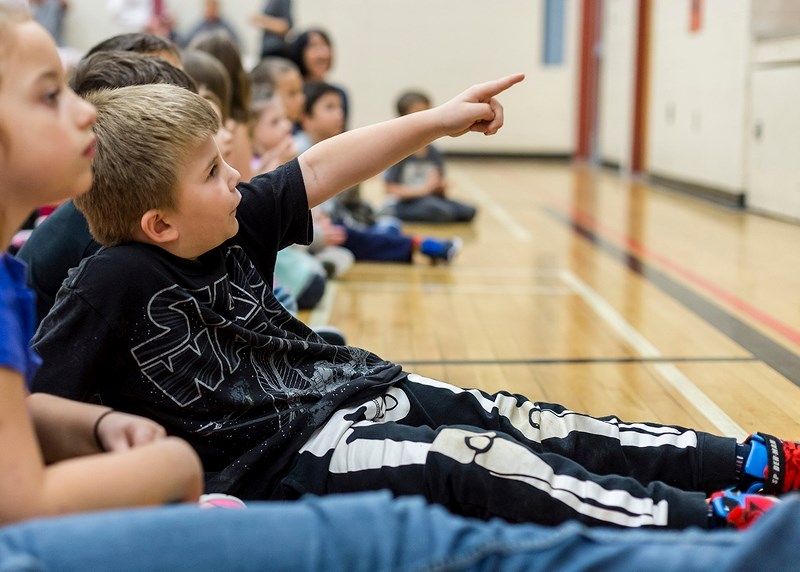 Malek Jutras, Grade 1 student at Boyle School, watches the Boyle Twilight Twirlers demonstrate square dancing during the school&#8217;s Multicultural Day Oct. 18.