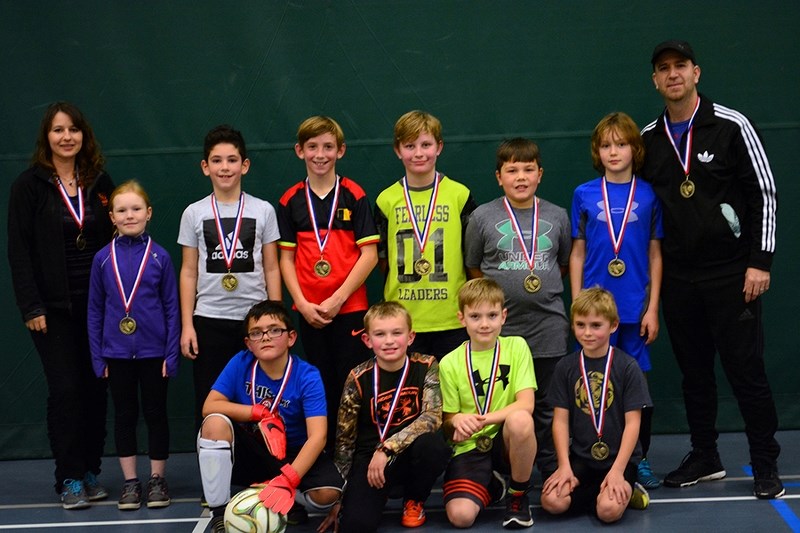 The Athabasca U10 soccer team poses with their medals on Nov. 6, awarded for an undefeated season in which they shutout all their opponents. (Back, L-R) Pam Ergang (assistant 