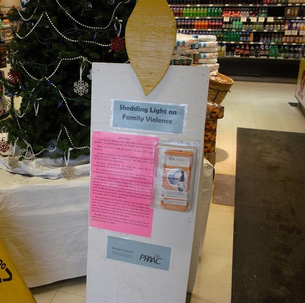 A wooden candle at Buy-Low Foods in Athabasca featuring the story of a victim of relationship abuse. The candle is one of six spread through town to commemorate Family