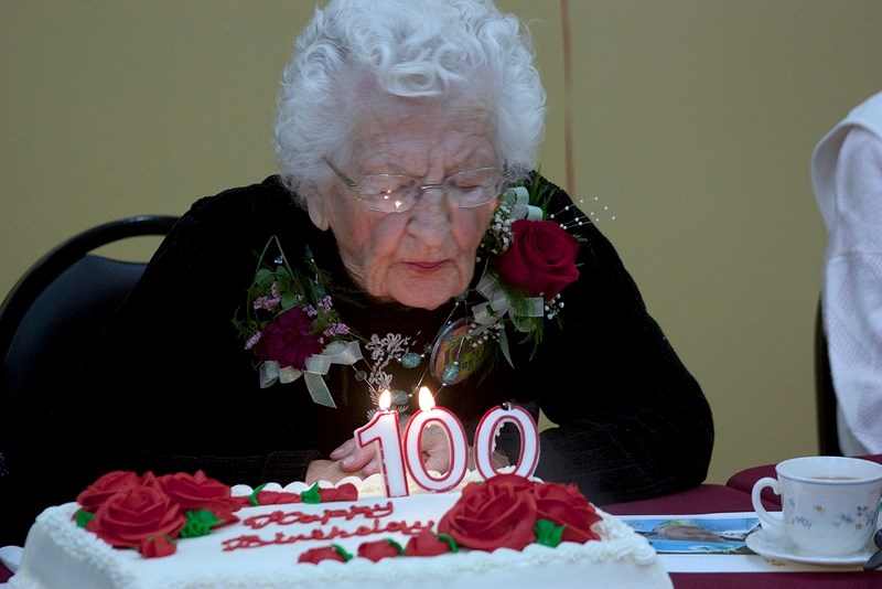 Pleasant Valley Lodge resident Alice Smith blows out the candles during her 100th birthday celebration on Nov. 18.