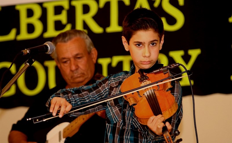 Hardy Kryvenchuk-Loomis (right) plays alongside grandfather Emile Kryvenchuk during the Alberta Men &amp; Women Country Music Festival May 13. The two play together in the