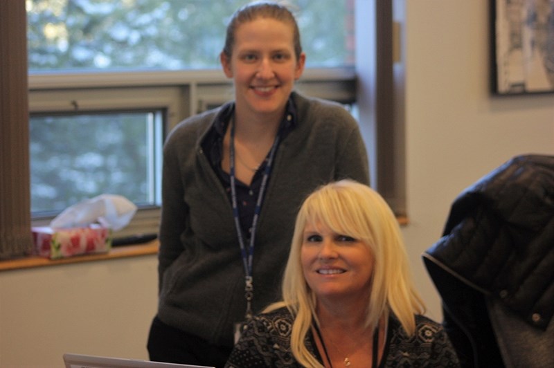 Alberta Emergency Management Association team lead Wendy Bryson (right) and case manager Emily Miles set up a disaster recovery program application centre at the Athabasca