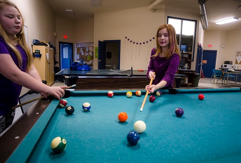 Siarra Johnson-Scanie plays pool with Ema Schulte at the Boyle Youth Centre Jan. 19. Youth centre president Melissa Gardner said the centre needs to attract more board