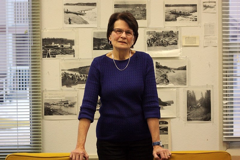 Former Athabasca archivist Marilyn Mol stands in front of a historic display at the archives Jan. 25. Mol&#146;s service was recognized by a photo of herself placed within