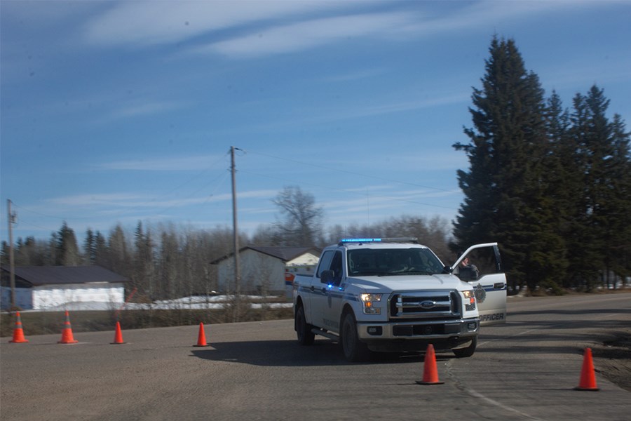Athabasca County peace officer Jeremy Oakes diverts traffic on Highway 827 April 20. The diversion was due to a police incident in which RCMP secured a scene around a