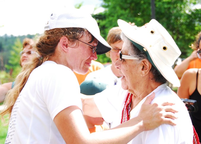  A tearful and exhausted Loutitt embraces Bertha Clark-Jones at the riverfront after the run July 19, 2008.