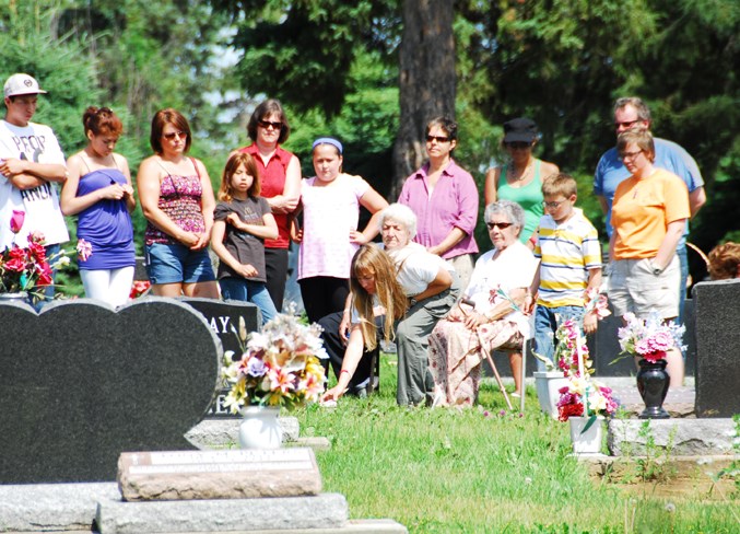  Friends and family gather at Loutitt’s great-grandmother’s grave to reunite hers and Billy Loutit’s spirit July 20, 2008.