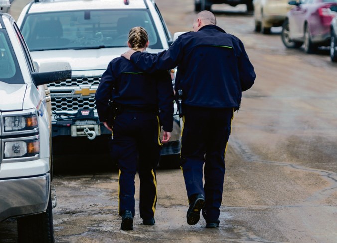  Athabasca RCMP Cpl. Dale Bereza (right) puts an arm around a constable at the scene March 2, 2018.