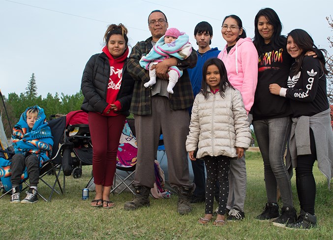  (L-R) Richard McLeod Jr., Syrena McLeod, Richard McLeod, Aris McLeod, Darren Beaver, Carly Stewart, Carla Beaver, Precious Yellow Knee and Jenna Auger stand beside the tents where they are sleeping by the Jay Bird Memorial Arena in Calling Lake May 30. The group evacuated from Wabasca early that morning.
