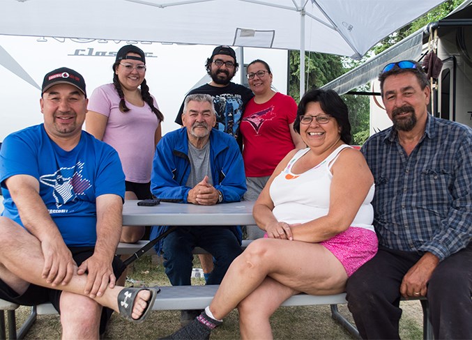  (L-R) Gilmen Cardinal, Fredelle Auger, Charlie Auger, Dalton Auger, Deanna Auger, and Melba and Fred Auger were in the “Auger Village” on the east side of Highway 813 by Calling Lake June 1.