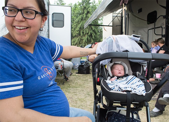  Gwen Madore sits with her 11-day-old son Oakley Madore June 1. The two evacuees are staying on Charlie Auger’s property. “I was only home for a few days, and then I had to come here,” she said.