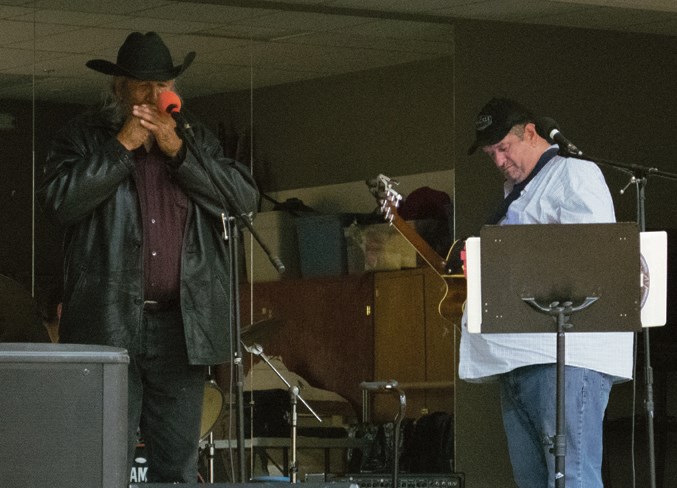  Alfred Beaver (left) plays the harmonica during the talent show, which ran as a part of Calling Lake's Treaty Day celebrations.