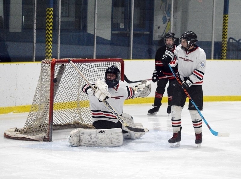 Barrhead goaltender Jonathan Verheul makes a blocker save in the early going of a game against Westlock.