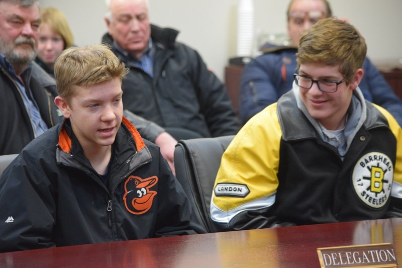 Jayden Cramer and Landon Petiot, of the Barrhead Midget Orioles, ask Barrhead town councillors for a town flag for their upcoming tour of Cuba.