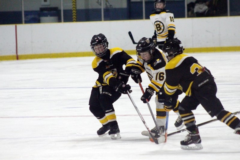 Barrhead Bolts player Brock Beauliua fights for possession of the puck during the first of a two-game, total-points series Jan. 19 for provincial playdowns at the Atom level. 