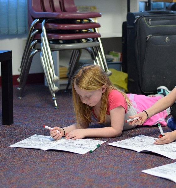 Halee Demone working on an Alberta Farm Safety Centre workbook after the presentation.