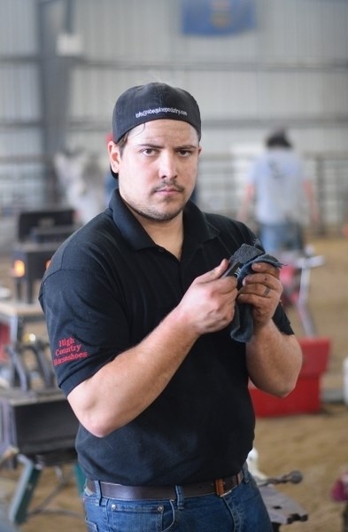 Joseph Goble, from Calgary polishes one of the horseshoes he finished in the Division 2 competition.