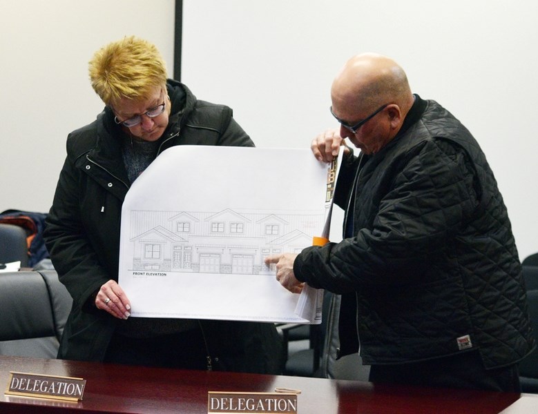 Hilda (l) and Laverne Frose describe some of the details of a four plex project during a Feb. 27 public hearing.