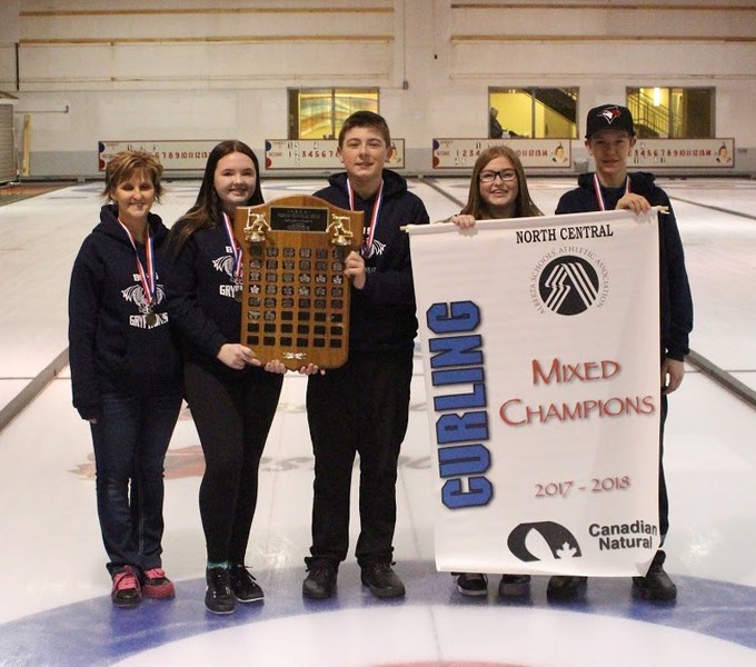 BCHS mixed curling team poses with the north central zone high school curling banner. From left: Krista Measures (coach), Reece Cerny (lead), Riley Schaffrick (second),
