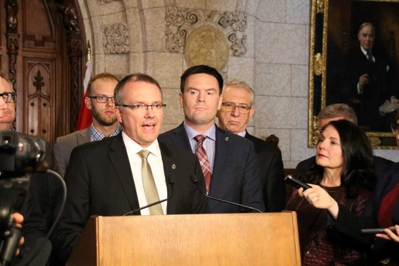 Conservative shaow ministers for Agriculture and Agr-Food Luc Berthold at the podium and John Barlow, behind right, Peace River-Westlock, behind left, and NDP Agriculture