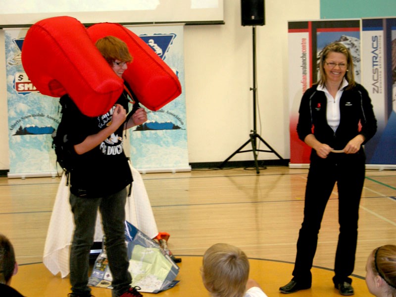 BCHS Grade 9 student Mason Graham displays an inflatable device used to protect outdoor enthusiasts should they be involved in an avalanche. Safety instructor Lori Zakaruk