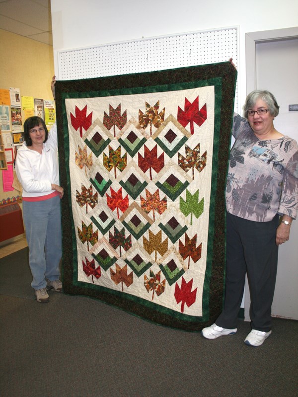 Barrhead Country Quilters president Jacquie Gross, right, and member Phyllis Nanninga show the Quilt of Valour 25 members worked on over the past several months. The quilt is 