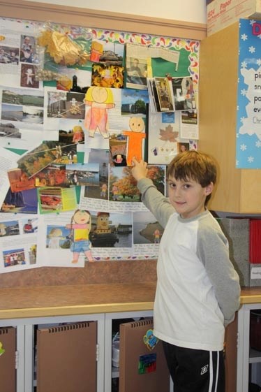 Paper boy: Curtis Summers points to his Flat Stanley paper cutout, which made the headlinesin Ont.