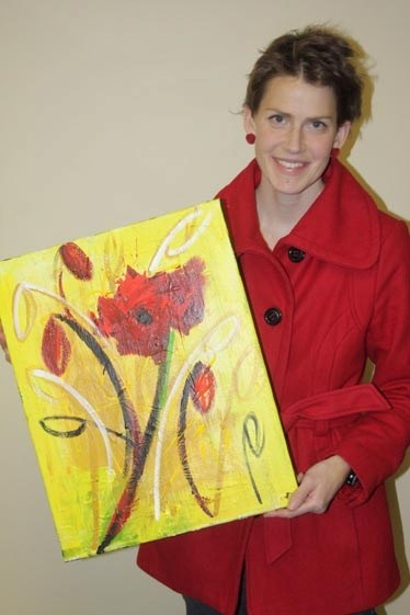 Flower power: Emily Wierenga displays one of her paintings, &#8220;Red Poppy.&#8221; Her work is on display at the Art Gallery.