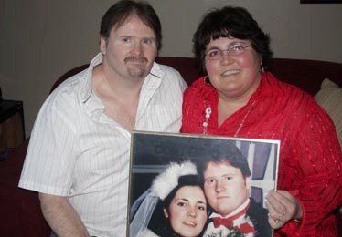 Silver wedding anniversary: Jeff and Marjolaine Loitz, both aged 47, who married on Valentine&#8217;s Day in 1987. They are pictured with a framed wedding day photograph.
