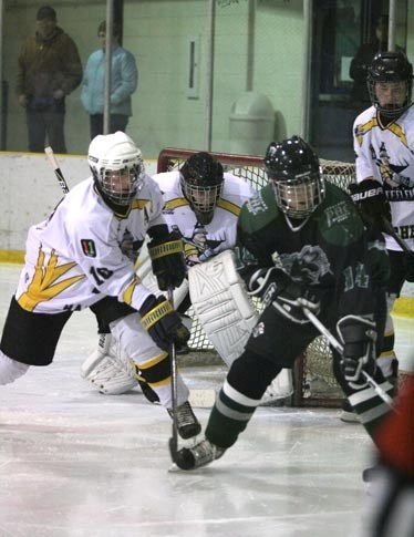 Steelers goalie Brandon Ryan stays focused on the puck as teammate Nolan Schmidt keeps a Spruce Grove Saints player away from the front of the net Feb. 15 at the Agrena.