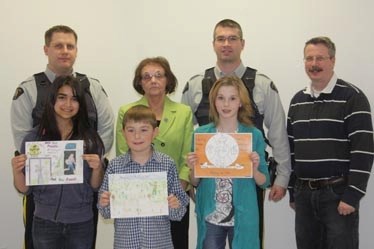 Poster children: Pictured holding their winning crime watch posters are Hannah Raju (Neerlandia Public Christian School), Riley Schaffrick (Barrhead Elementary School) and