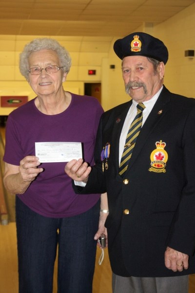 Legion president Vern Frizzell presents a cheque to The Bowling Association&#8217;s Elsie Measures.