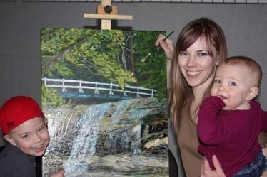 Picture perfect: Megan Leah Pederson with her painting, West Coast Hike. With her is three-year-old Alex and 10-month-old Shelby. As an artist, Megan uses her middle name,