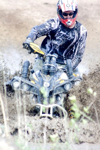 Powering through the heavy terrain, a quad rider shows his skill, strength and concentration.