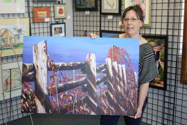 Laura Cox with her latest painting, Dance of Light.