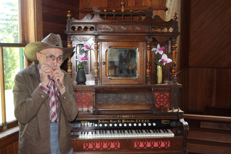 Man of note: Doug Gibb plays his harmonica next to the organ at Belvedere Community Church.