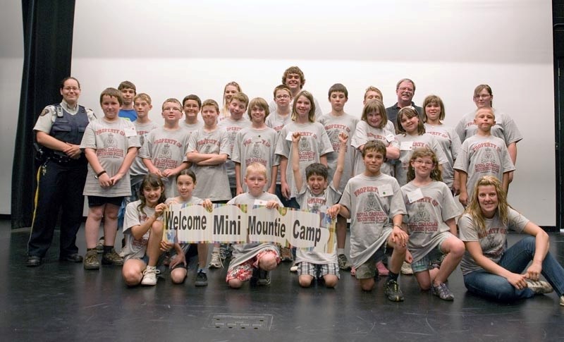 Graduates of the 2012 Mini Mounties camp smile proudly after their two-day adventure, which included an ambulance demonstration, car crushing, self defence, crime