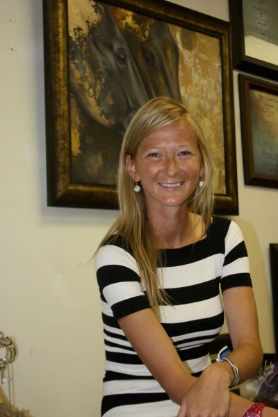 Estonian artist Helis Podnek pictured at Barrhead&#8217;s chez Elize Gallery at the Right Angle Framing and Design. In the background is one of her paintings of horses.