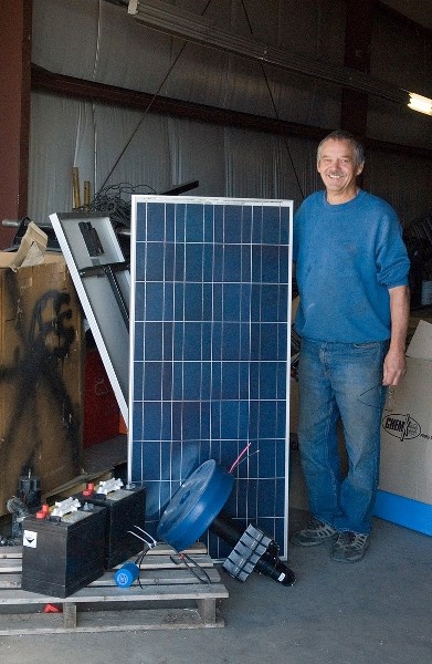 Vern Stocking, owner of solar business Solar Works in Barrhead, stands with the four main components making up a solar water pump used by farmers all over Alberta.